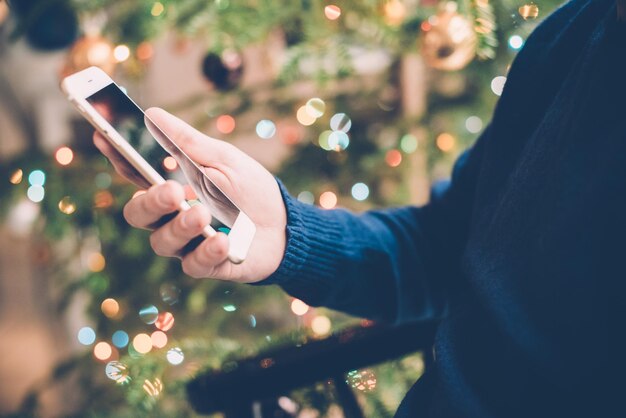 Man relaxing at home with smartphone in his hand