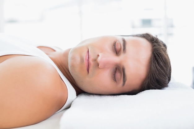 Man relaxing on massage table in medical office