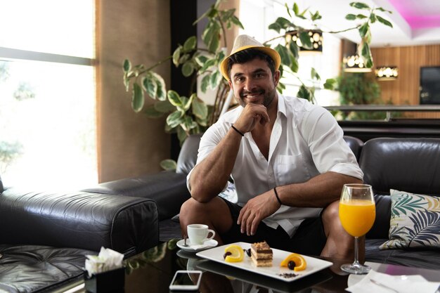 Man Relaxing on Sofa in Hotel Lobby Bar