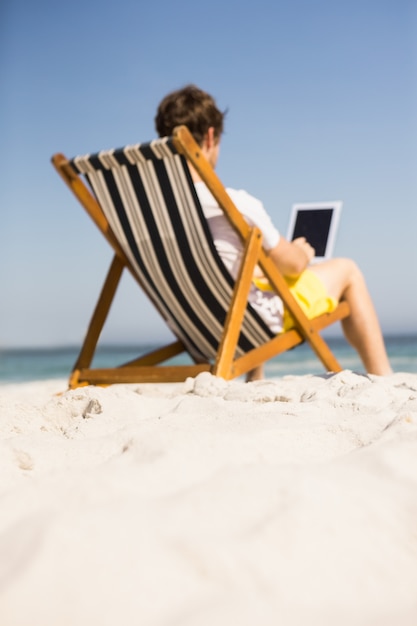 Man relaxing and using tablet