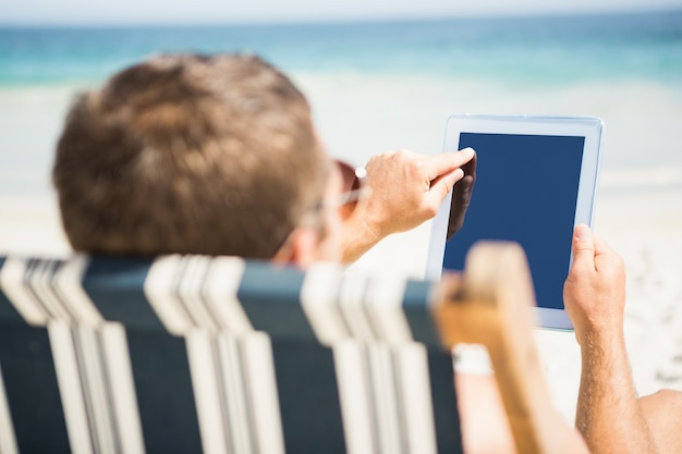 Man relaxing and using tablet