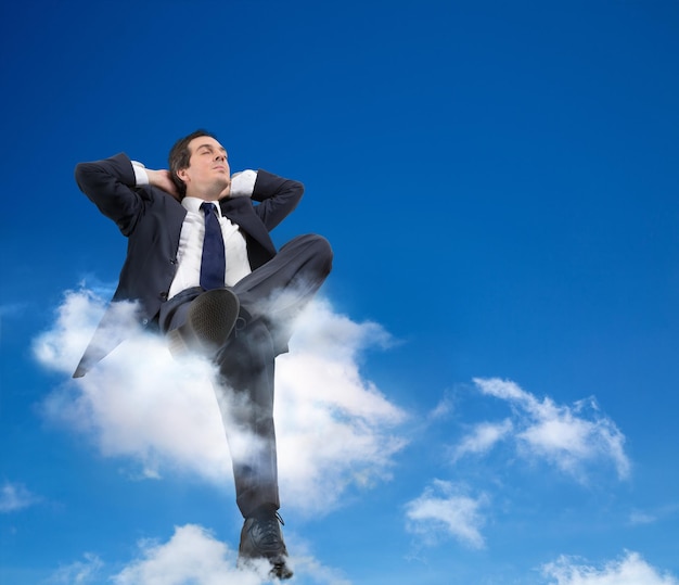 man relaxing with head in the clouds