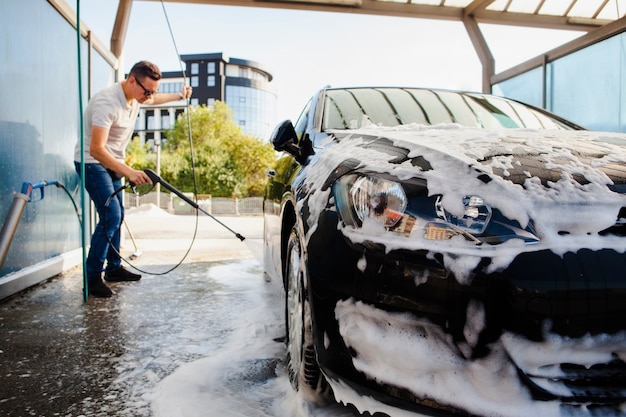 Man removing foam from a car