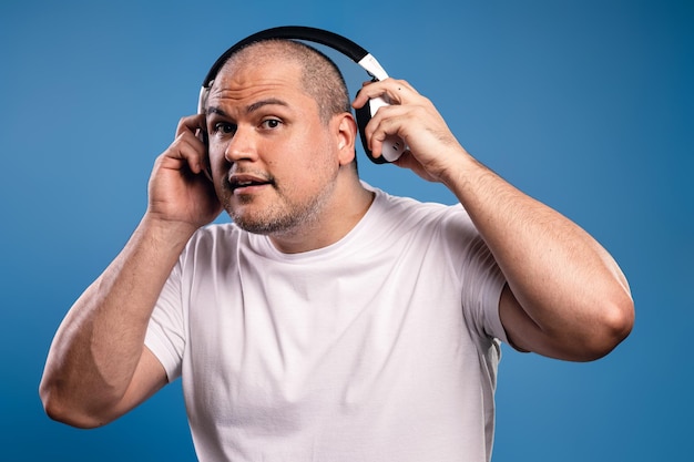 man removing his headphones