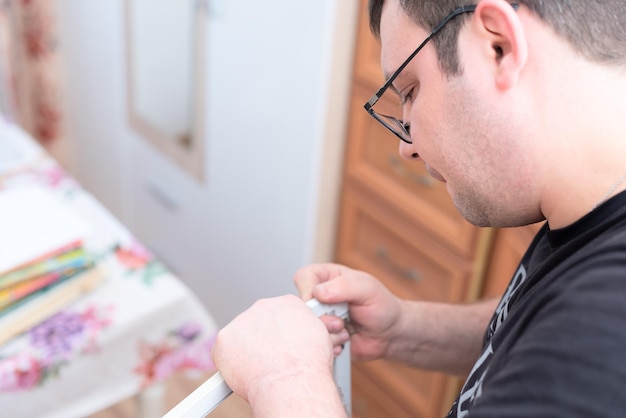 Man repairing mosquito net at home Home improvement concept