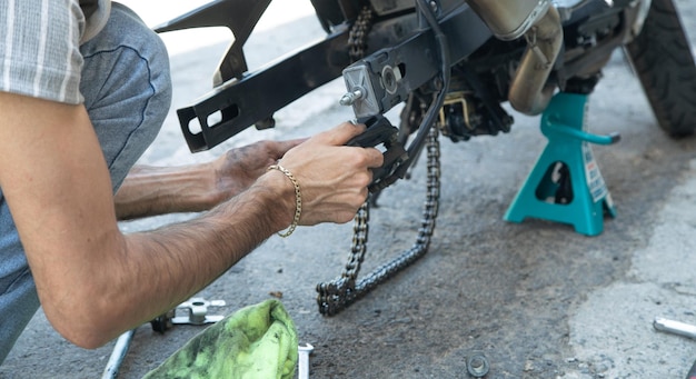 Man repairing motorcycle chain Sport Hobby