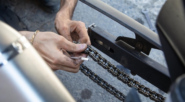 Man repairing motorcycle chain Sport Hobby