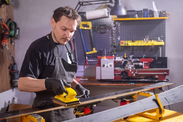 A man repairing the ski in the service