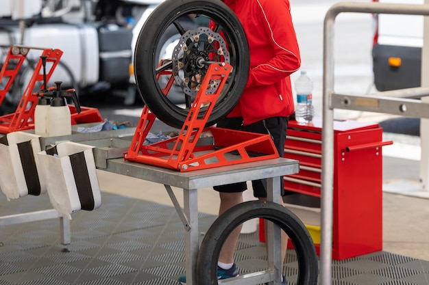 Photo a man repairing a tire on a cart with determination and skill