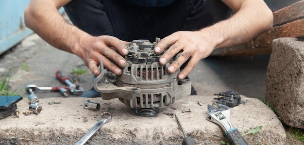 Man repairs car alternator Service center