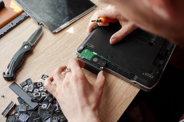 Man repairs laptop by himself computer repair