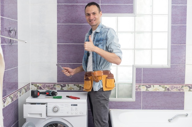 man repairs a washing machine.