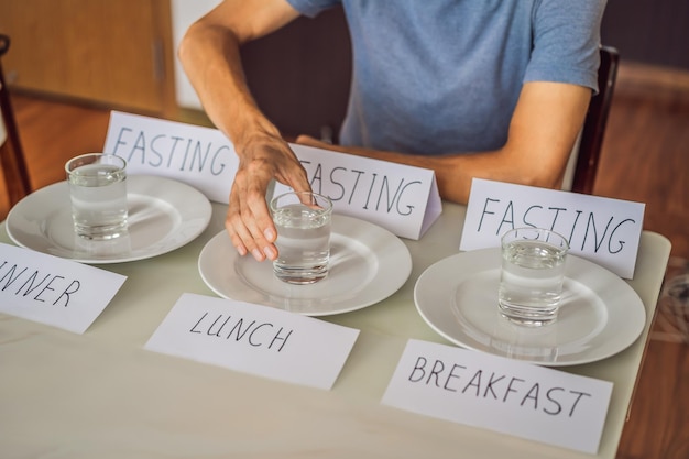 Photo the man replaces his meals with water intermittent fasting concept top view