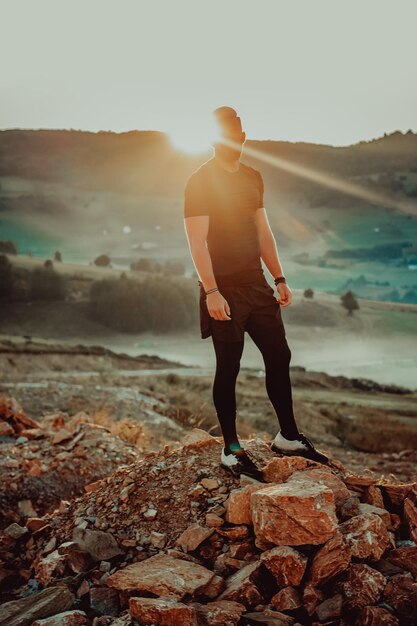 Man rest on top of mountain after training.Motivation concept