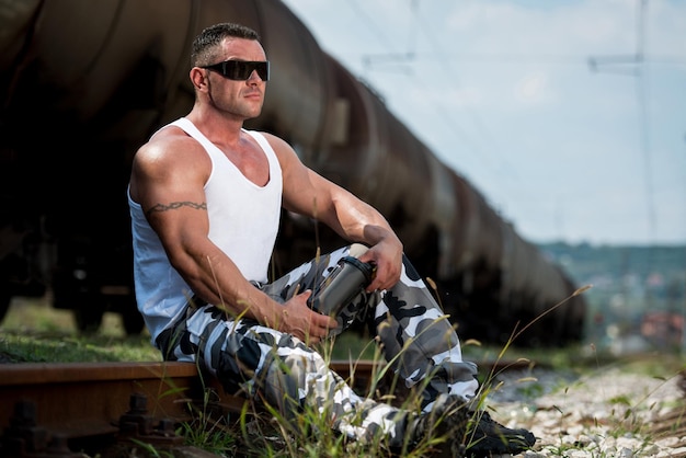 Man Resting And Holding Protein Shake