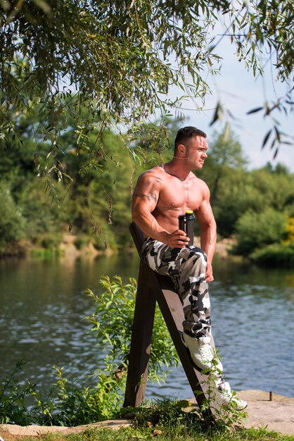 Man Resting And Holding Protein Shake