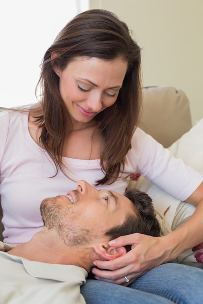 Man resting on womans lap on couch