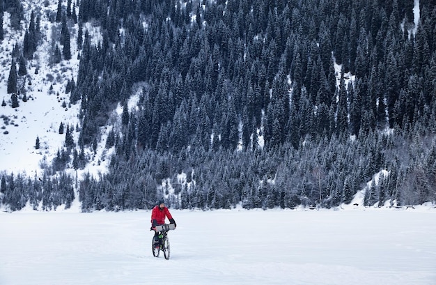 Man ride bicycle at frozen lake