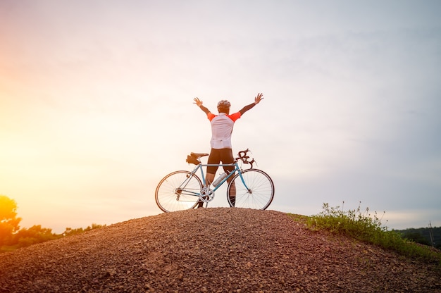 A man ride on bike on the mountain man riding vintage sports\
bike for evening exercise