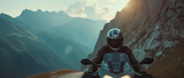 Photo a man rides a scooter on a road with mountains in the background