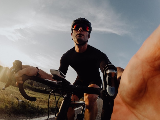 Man riding bicycle against sky