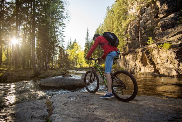 man riding on a bike through the mountain