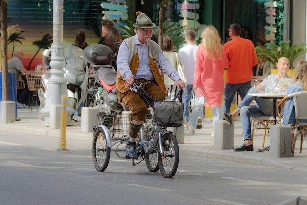 a man riding a bike with a bag on the back of his head