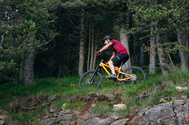 Man riding a mountain bike through a forest