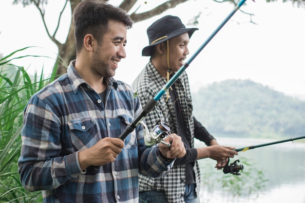 Man on the riverbank fishing fish