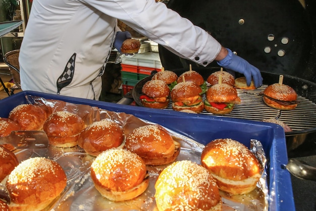 a man roasts burgers on special equipment