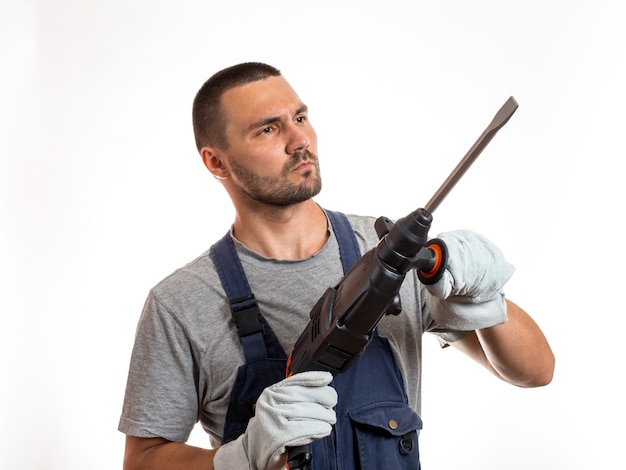 A man in robo-like clothes holds a hand punch, ready to work, on a white background.