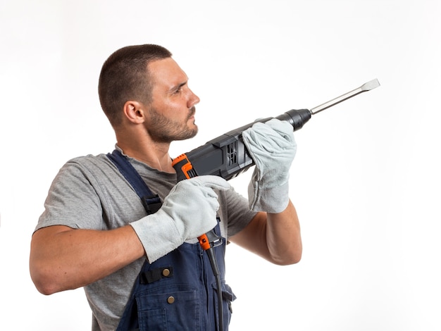 A man in robo-like clothes holds a hand punch, ready to work, on a white background.