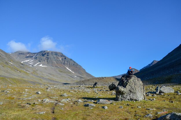 Man on rock at field