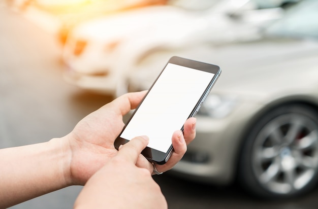 Man roept auto met mobiele telefoon app op parkeerplaats