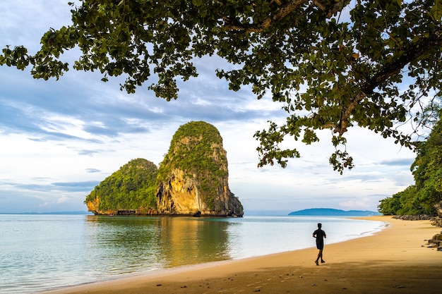 A man runing in the morning at Pranang Cave Beach, Railay, Krabi, Thailand