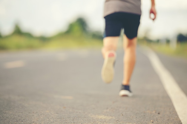 Man runner on the road to healthy, Young people running exercise on street.