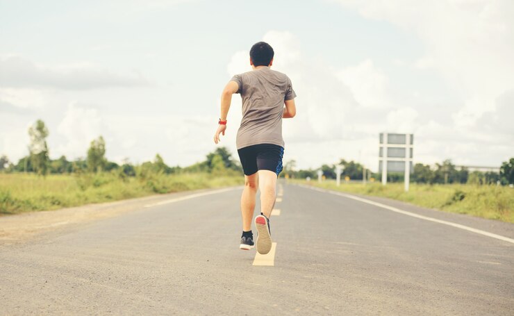 Photo man runner on the road to healthy, young people running exercise on street.