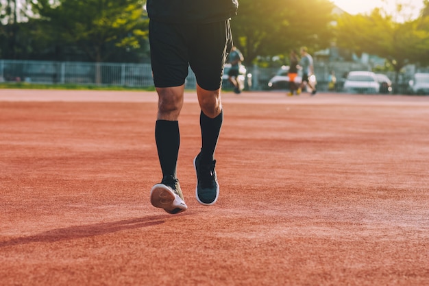 Man running in evening at sunlight