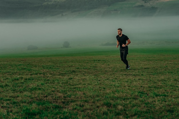 Man running on meadow in morning time