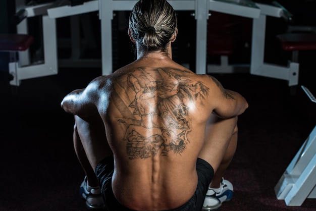 Man rust na oefeningen in de sportschool