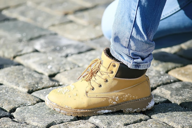 man’s foot in a shoe on a paving block, a pedestrian,