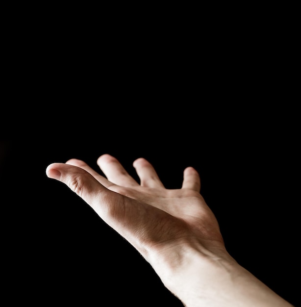 Man's hand on a black background