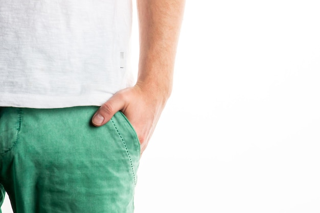 Man's hand in his pocket closeup on a white background green men pants