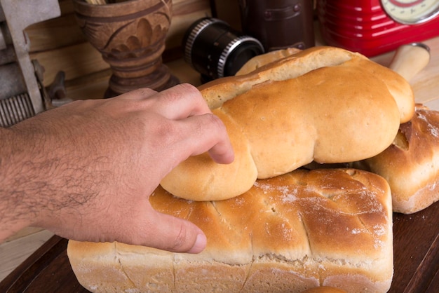 Man's Hand Holding Bread