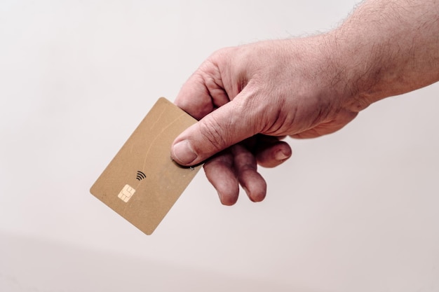 Man's hand holding credit card Isolated on white