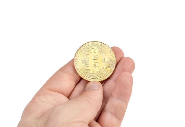 Man's hand holding golden coin of bitcoin Isolated on white