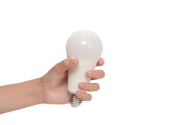 man's hand holding a light bulb on a white background