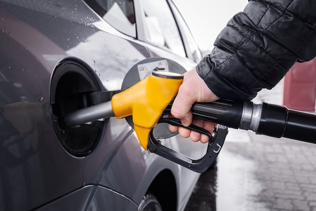 Man's hand holding a refueling gun