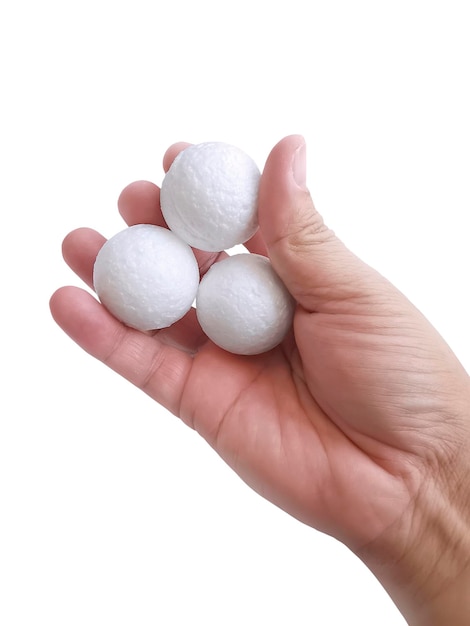 Man's hand holding three white blank styrofoam ball against the white background3