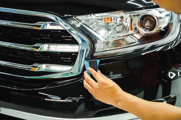 Man's hand is taking care of car maintenance at garage